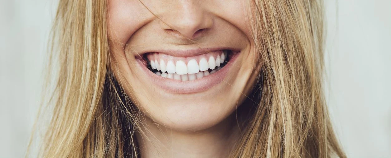 Close-up of a smiling mouth with healthy-looking teeth.